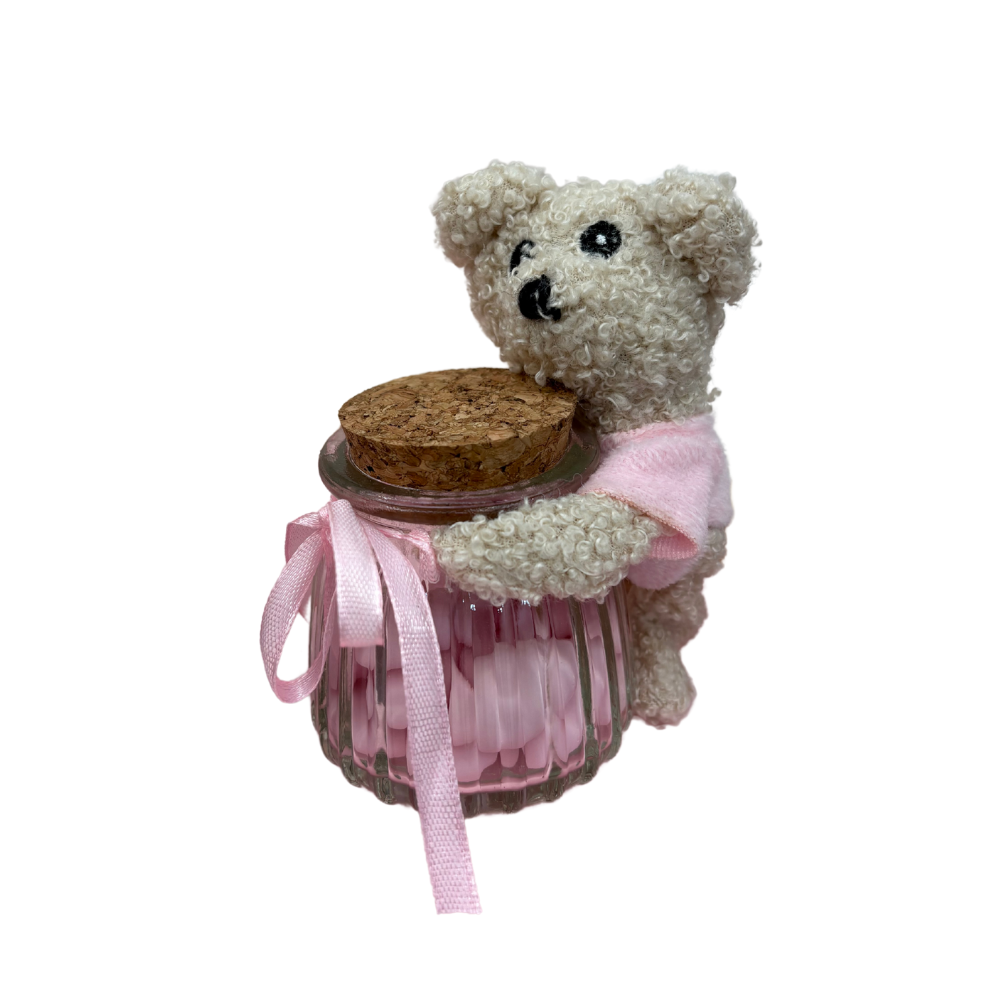 Piccolo orsetto con nastrini rosa